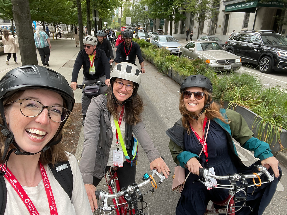 Smiling women cycling, conference lanyards visible