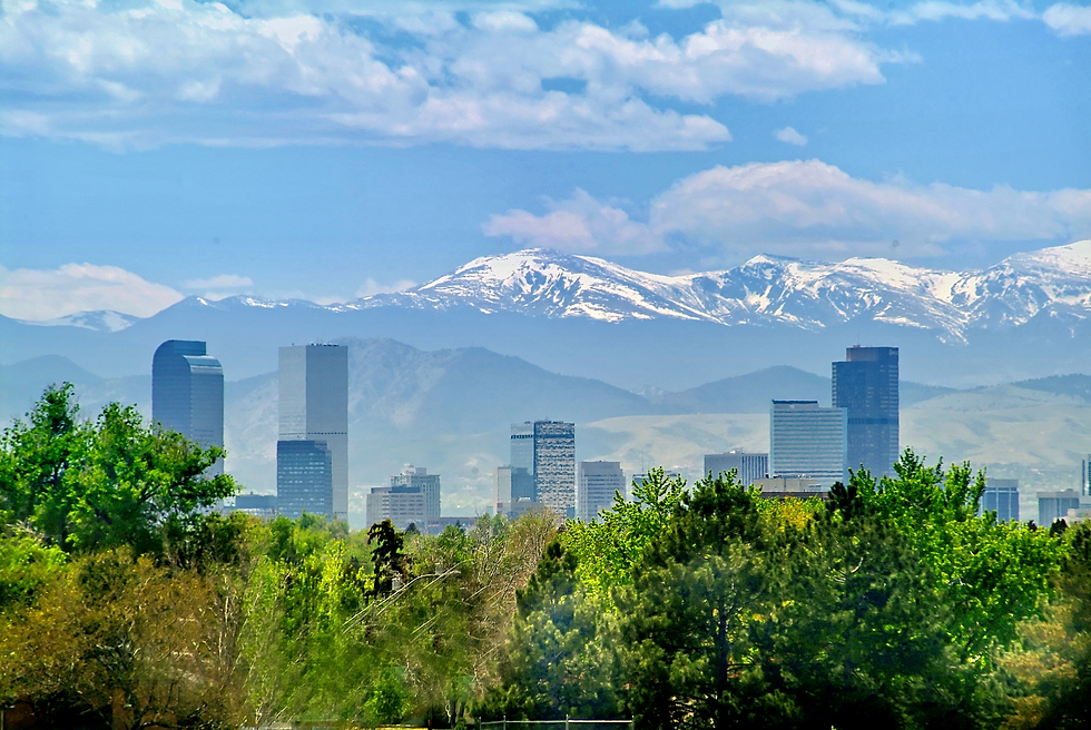 Denver skyline with snow-capped Rocky Mountains in background