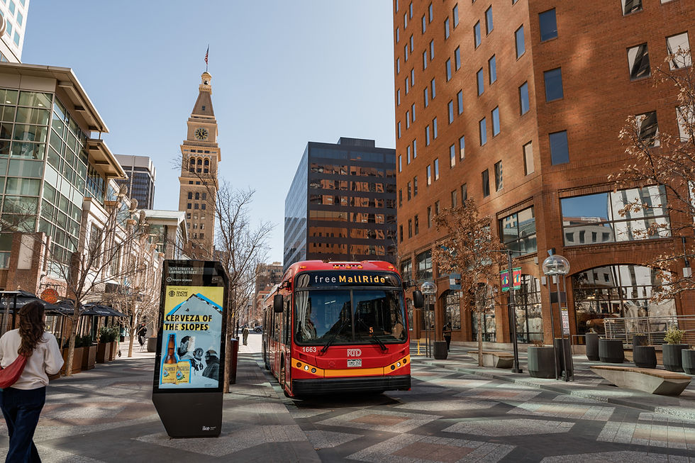 Red bus on city street near Denver Clocktower