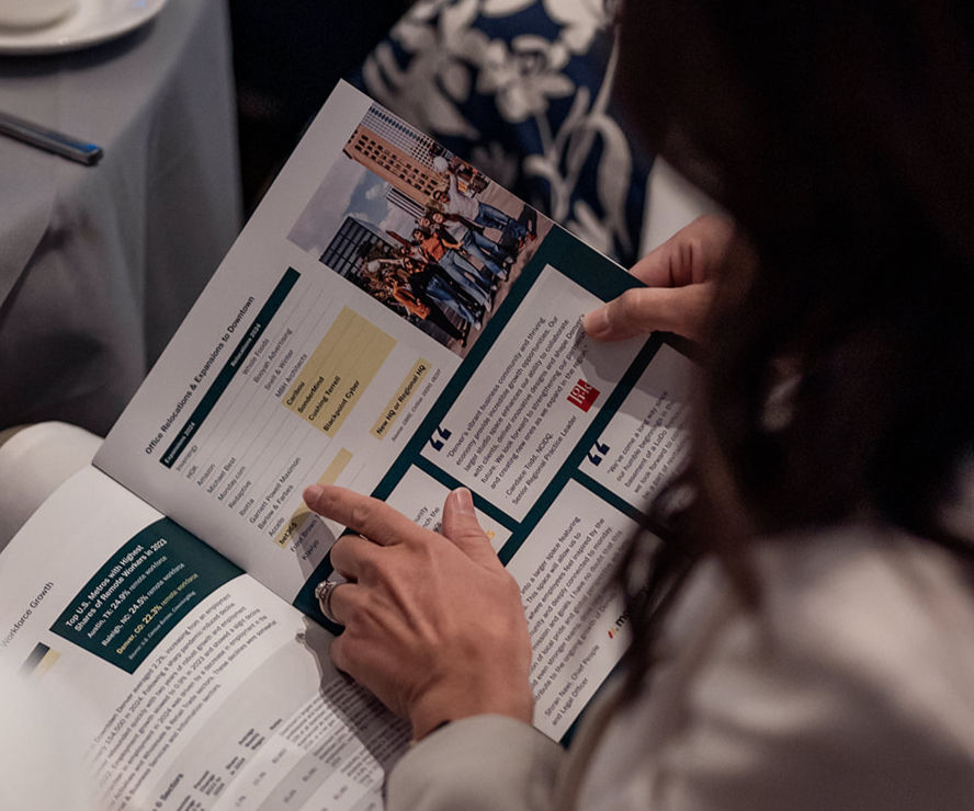 Person reviewing brochure with event details